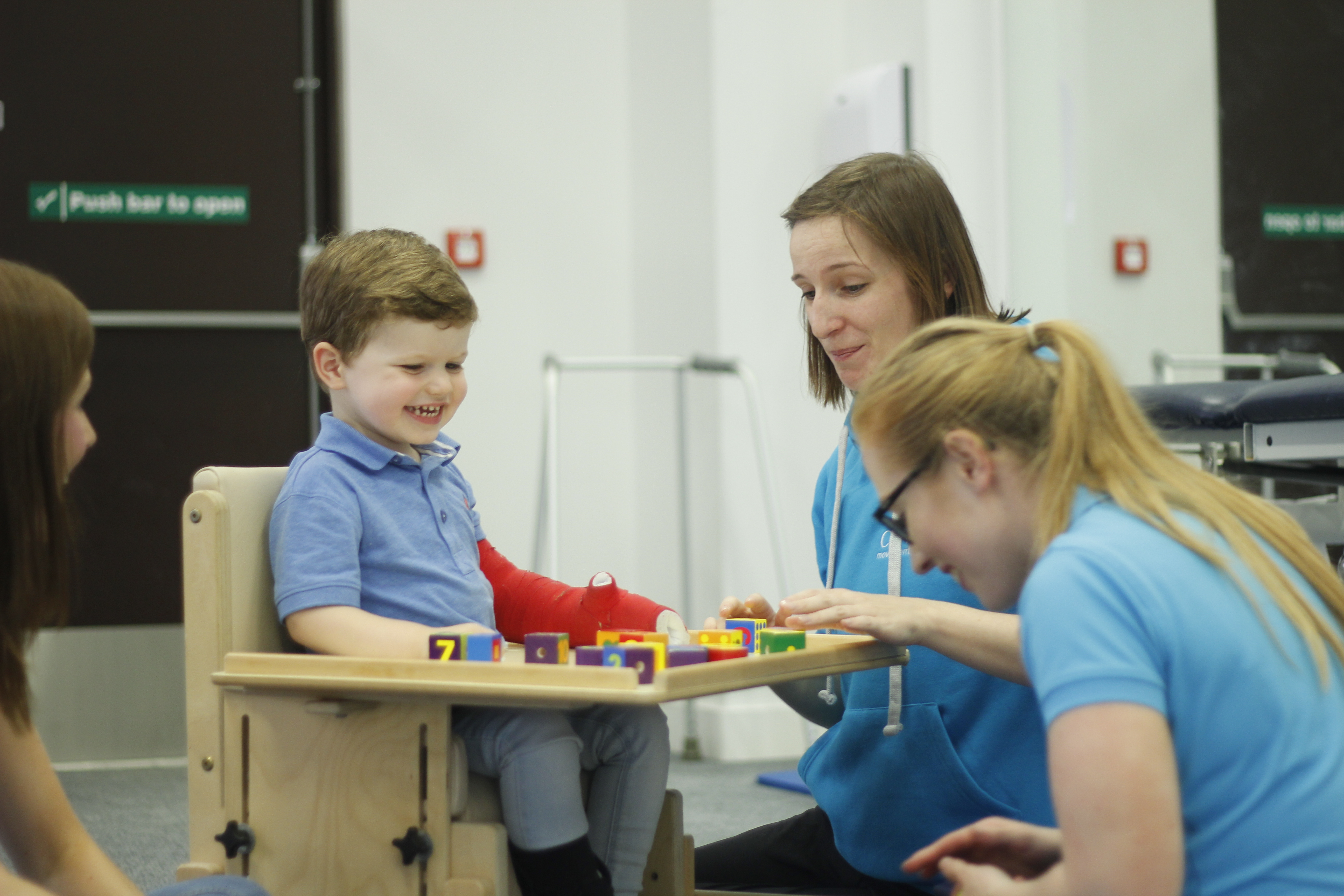 Finlay playing with building blocks with CIMT therapists