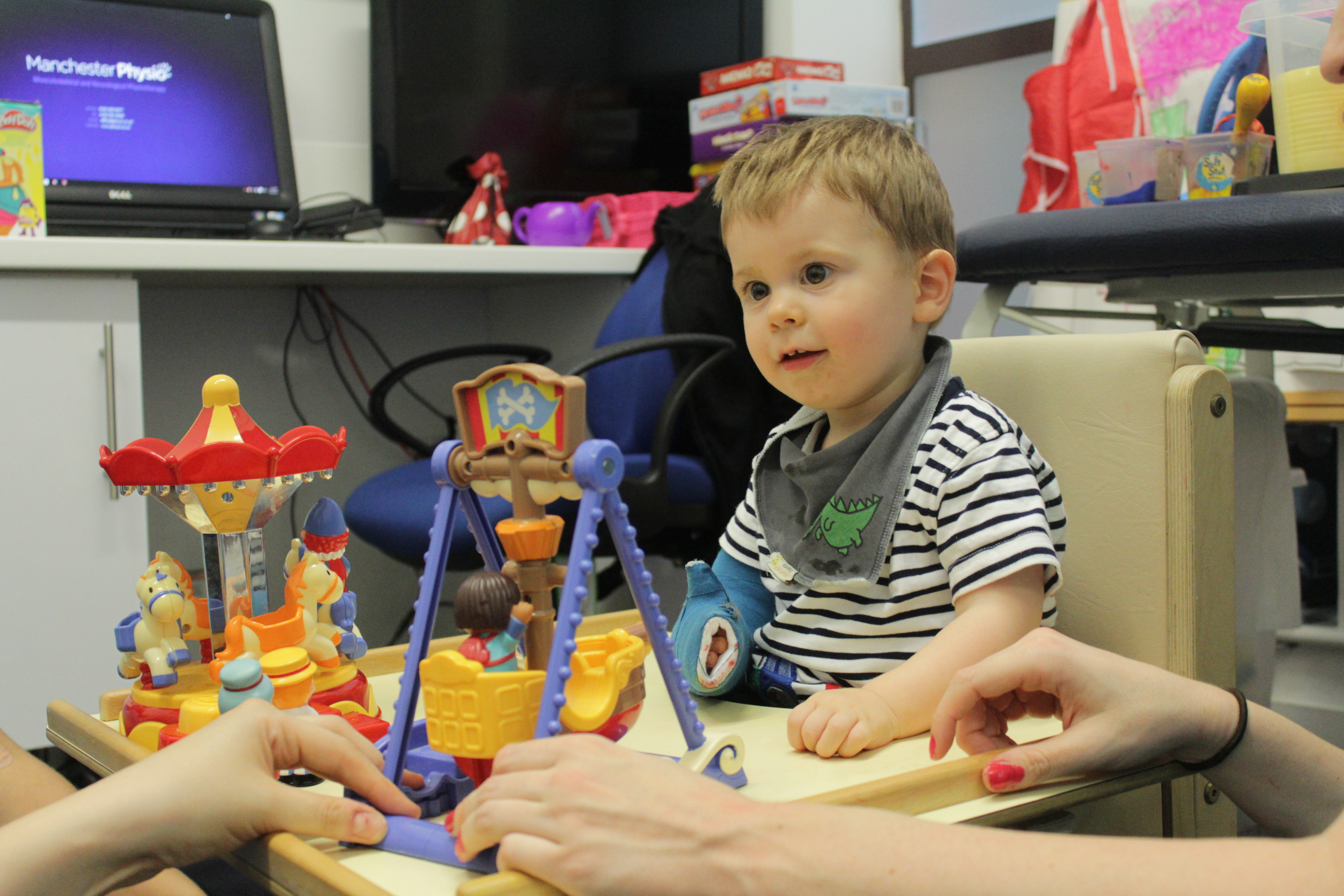Thomas playing with toys during CIMT treatment