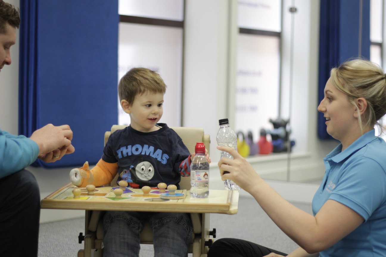 Thomas playing with toys during CIMT treatment