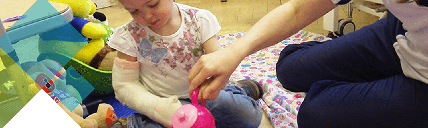 Child with cast applied plays during an activity