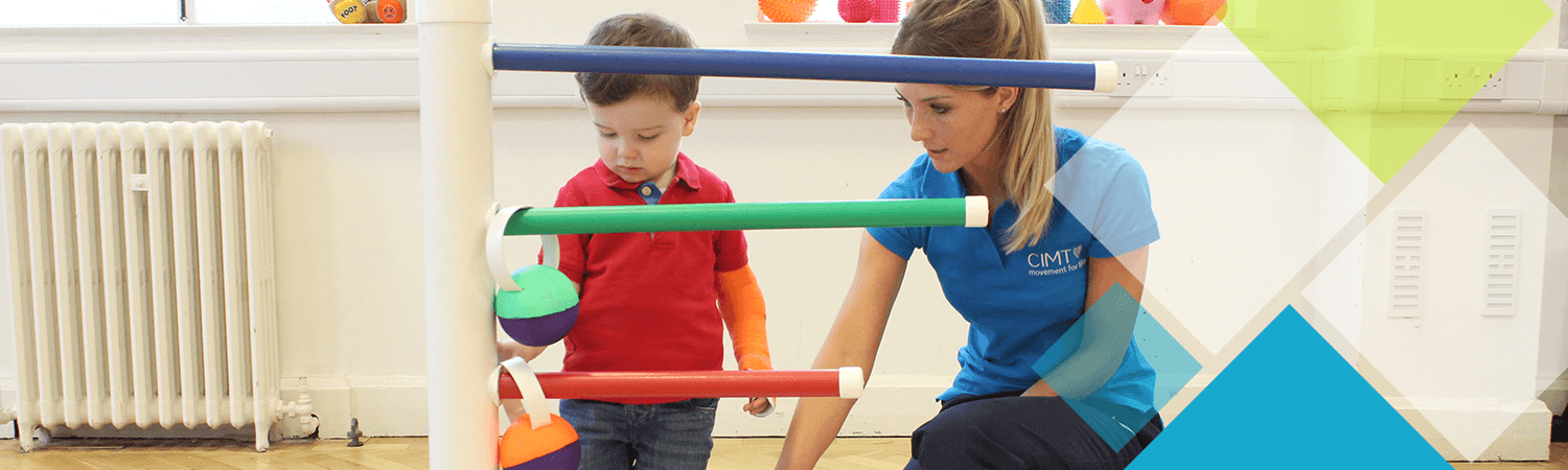 Young child plays during an activity with a CIMT physiotherapist